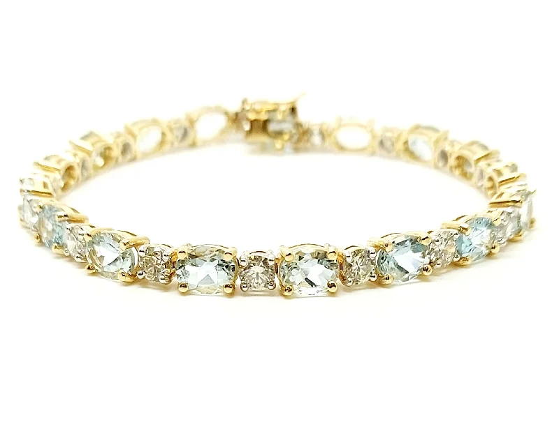 ladies-artisan-diamond-bracelets-Oval Aquamarine And Round Diamond Bracelet In 14k Yellow Gold